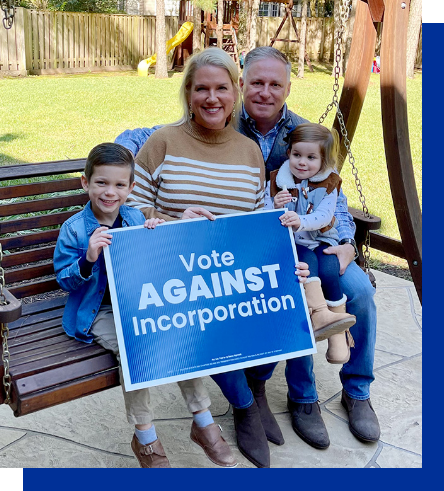 Brad Bailey and his family holding a “Vote Against Incorporation” sign